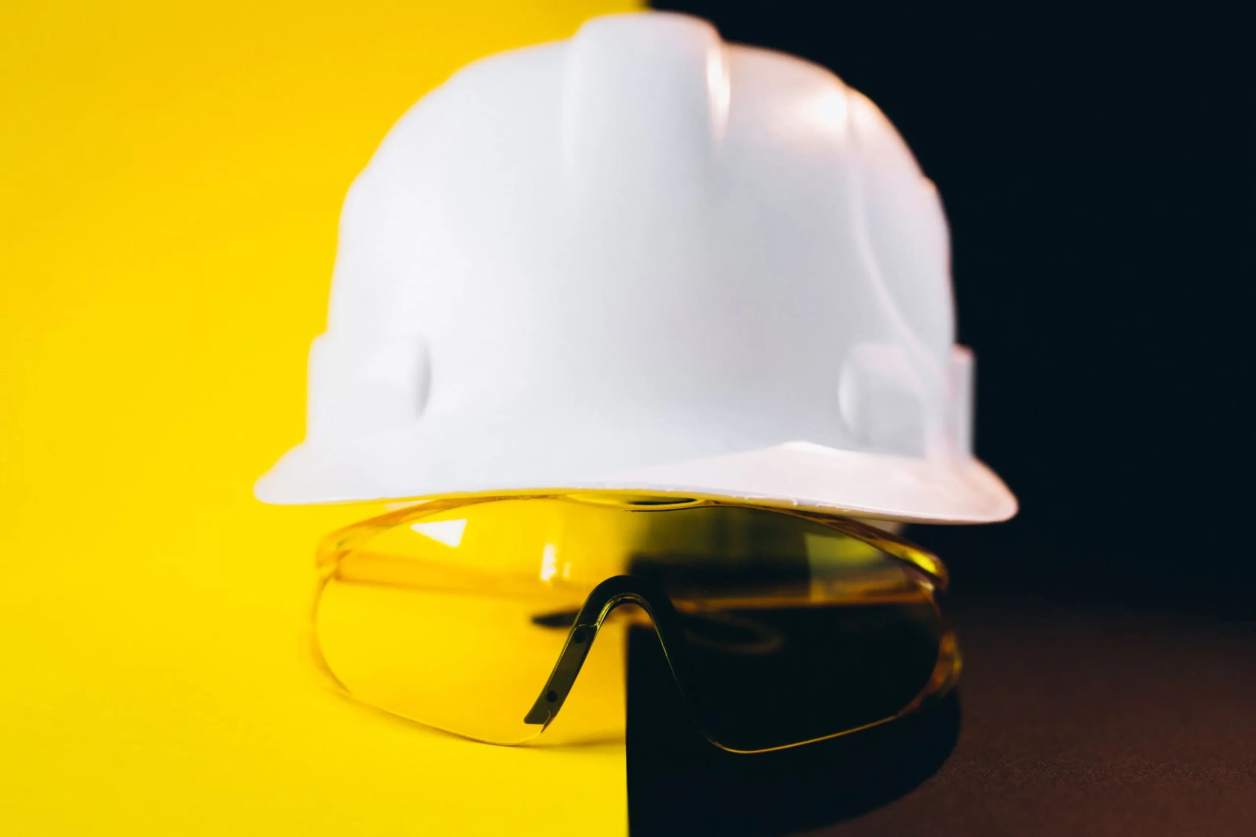 White hard hat with protection eyeglasses isolated